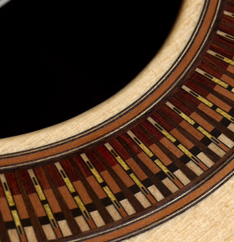 Closeup detail of the rosette of a 2026 Richard Reynoso classical guitar made of spruce and Indian rosewood