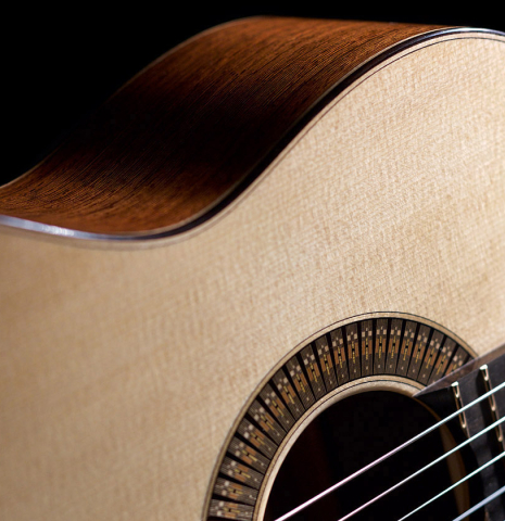 The soundboard, rosette and side of a 2022 Richard Reynoso classical guitar made of spruce and wenge