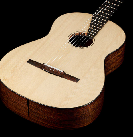 The soudboard of a 2024 Richard Reynoso w/pegs classical guitar made of spruce and Indian rosewood