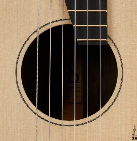 The soundhole of a 2024 Richard Reynoso w/pegs classical guitar made of spruce and Indian rosewood