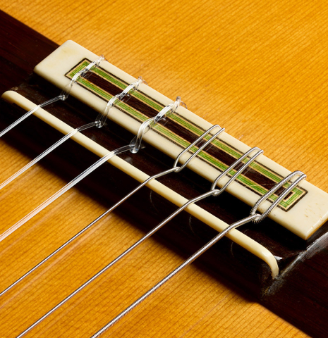 The bridge, tie-block and saddle of a 1996 Manuel Reyes classical guitar made of cedar and CSA rosewood