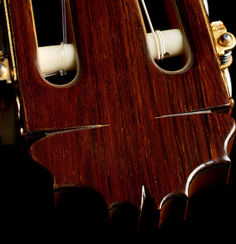 The carved headstock of a 1996 Manuel Reyes classical guitar made of cedar and CSA rosewood