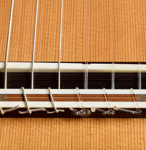 The bridge, tie-block and saddle of a 2023 Richard Reynoso classical guitar made of cedar and wenge