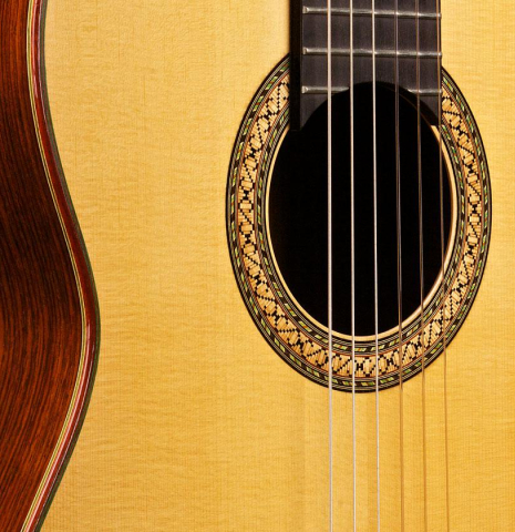 The soundboard and rosette of a 1996 Mikhail Robert classical guitar made of spruce and Indian rosewood