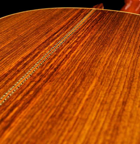 The back center seam of a 1996 Mikhail Robert classical guitar made of spruce and Indian rosewood
