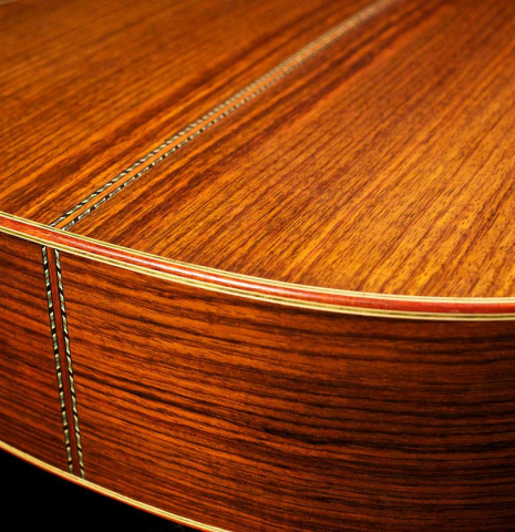 The back and sides of a 1996 Mikhail Robert classical guitar made of spruce and Indian rosewood