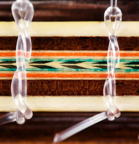 The detailed and ornamented bridge of a 1979 Miguel Rodriguez &quot;Churchdoor&quot; guitar made with cedar soundboard and CSA rosewood back and sides