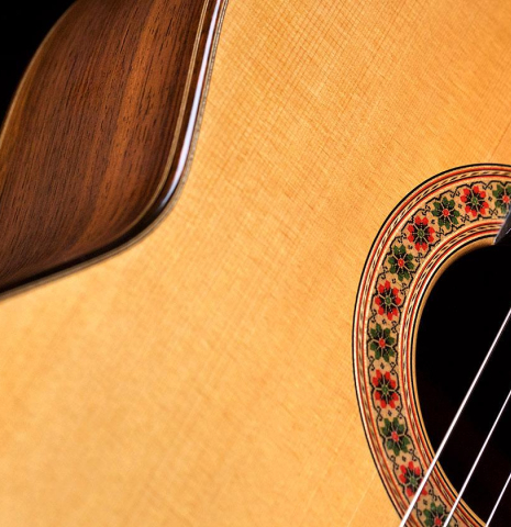 The soundboard and rosette of a 1987 Miguel Rodriguez classical guitar made of spruce and Honduran rosewood