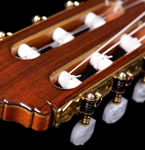The headstock and machine heads of a 1987 Miguel Rodriguez classical guitar made of spruce and Honduran rosewood