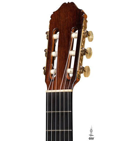 The headstock and machine heads of a 1962 Miguel Rodriguez classical guitar on a white background
