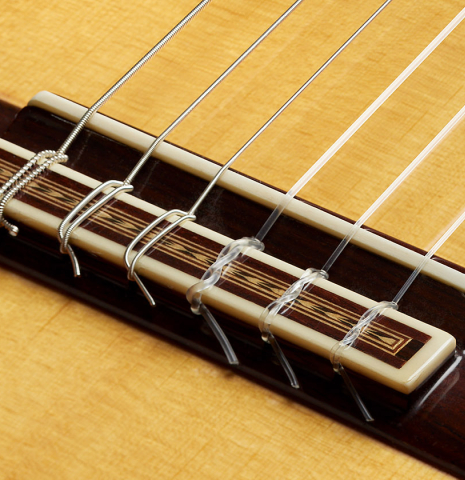 The bridge, tie-block and saddle of a 1991 Miguel Rodriguez "Centenario" classical guitar made of spruce and CSA rosewood