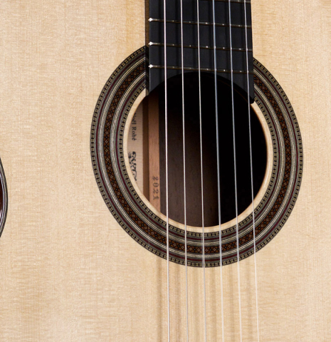 The soundboard and rosette of a 2021 Jean-Noel Rohe classical guitar made of spruce and CSA rosewood