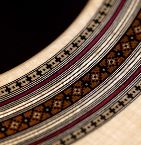 A close-up of the rosette a 2021 Jean-Noel Rohe classical guitar made of spruce and CSA rosewood