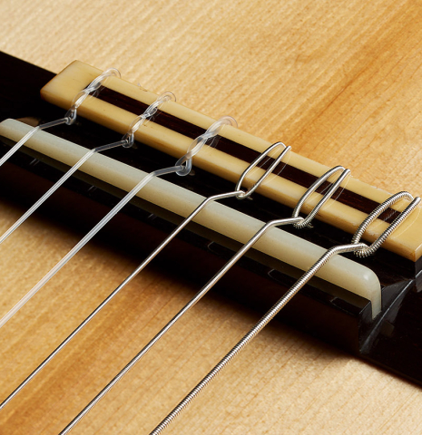 The bridge, tie-block and saddle of a 2024 Jean-Noel Rohe classical guitar made of spruce and CSA rosewood
