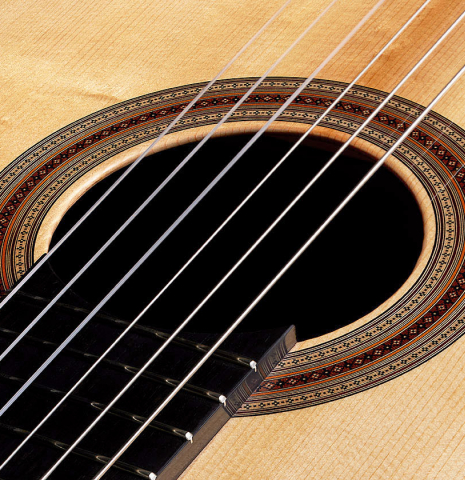 Detailed close-up of the rosette of a 2024 Jean-Noel Rohe classical guitar made of spruce and CSA rosewood