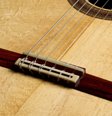 The bridge, tie-block and saddle of a 2025 Jean-Noel Rohe classical guitar made of spruce and CSA rosewood