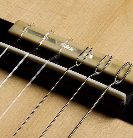 The bridge, tie-block and saddle of a 2026 Jean-Noël Rohé classical guitar made of spruce and CSA rosewood