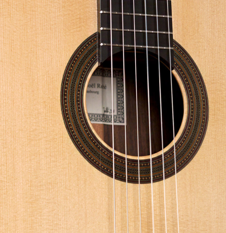 The soundboard of a 2011 Jean-Noel Rohe classical guitar made of spruce and Indian rosewood