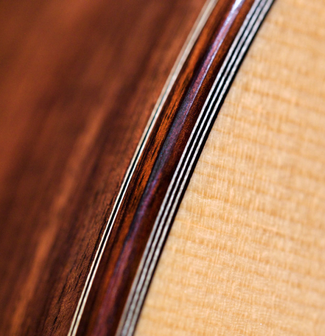 The binding and purfling of a 2011 Jean-Noel Rohe classical guitar made of spruce and Indian rosewood