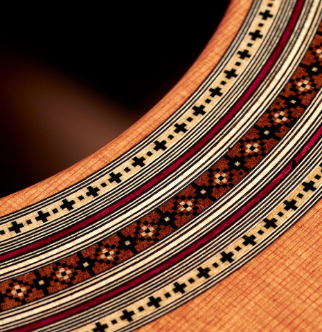 This is a close-up of the rosette of a 2022 Jean-Noel Rohe classical guitar made with cedar and CSA rosewood back and sides