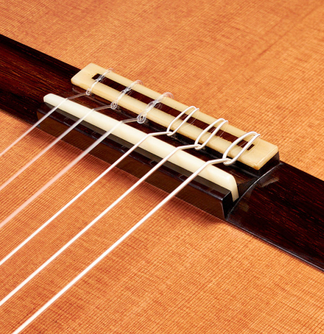 This is the bridge and saddle of a 2022 Jean-Noel Rohe classical guitar made with cedar and CSA rosewood back and sides