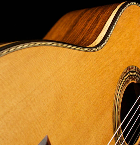 The cedar soundboard of a 2015 Pepe Romero "Centenario" classical guitar made with CSA rosewood back and sides