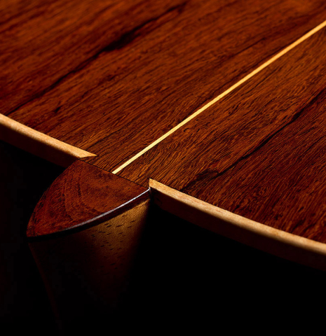 The heel, back binding and purfling of a 2025 Pepe Romero classical guitar made of cedar and African rosewood