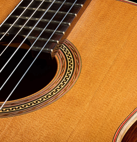 The soundboard and rosette of a 2025 Pepe Romero classical guitar made of cedar and African rosewood