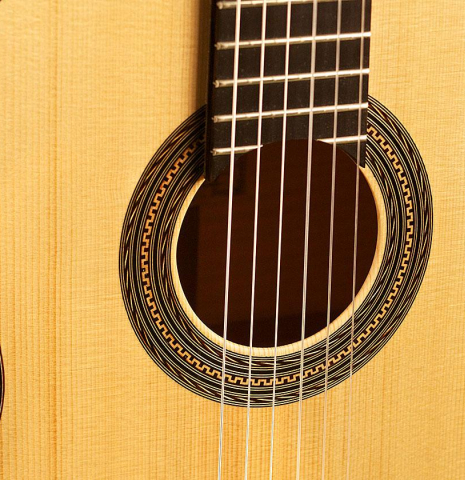 The top and rosette of a 2013 Pepe Romero classical guitar made of spruce and maple
