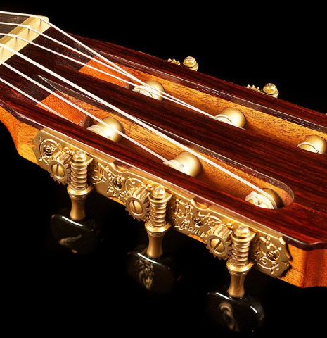 The headstock and tuning machines of a 2013 Pepe Romero classical guitar made of spruce and maple
