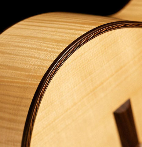 The top binding and purfling of a 2013 Pepe Romero classical guitar made of spruce and maple