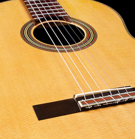 The soundboard and bridge of a 2017 Pepe Romero "Centenario" classical guitar made of spruce and CSA rosewood