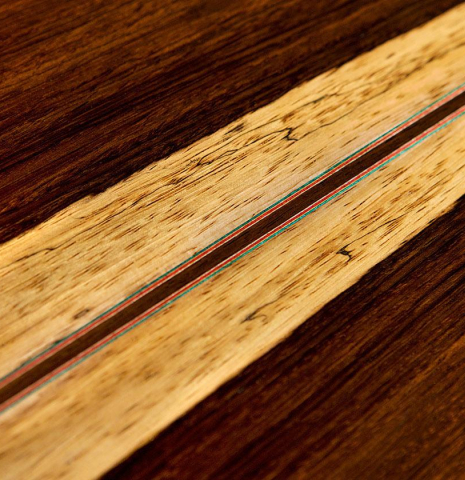 Closeup of the back center seam of a 2012 Pepe Romero classical guitar (ex Vicente Coves) made with cedar and CSA rosewood.
