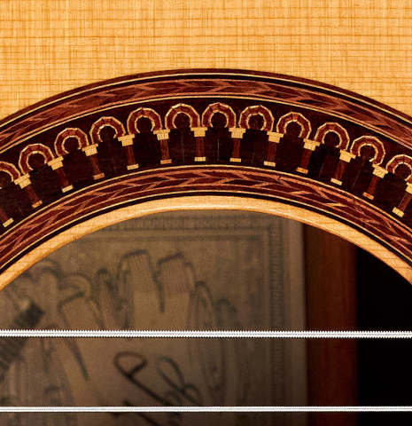 A close-up of the rosette of a 1982 Jose Romanillos "La Velez" classical guitar made of spruce and CSA rosewood