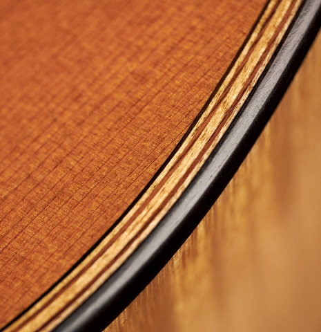 The top purfling and binding of a 2007 Pepe Romero classical guitar made of cedar and maple