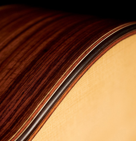 The sides and top purfling of a 2017 Jose L. Romanillos &amp; Son "La Campanula Azul" classical guitar made with spruce and Indian rosewood.