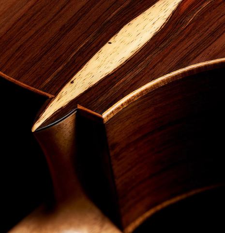 The heel, back binding and purflings of a 2024 Pepe Romero "cutaway" classical guitar made of spruce and CSA rosewood