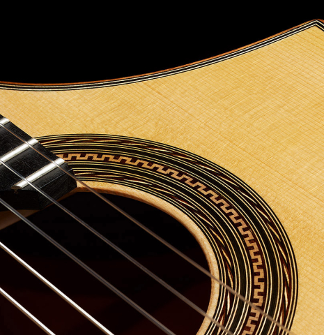 Detailed closeup of the rosette of a 2024 Pepe Romero "cutaway" classical guitar made of spruce and CSA rosewood