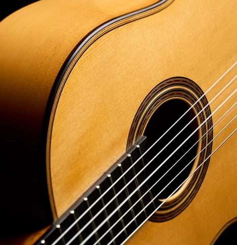 The soundboard and side of a 2006 Pepe Romero classical guitar made of spruce and cypress