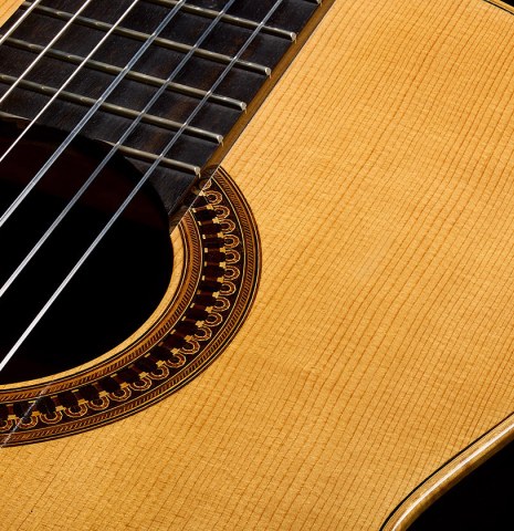 The top, fingerboard and soundhole of a 1981 Jose Romanillos "La España" classical guitar made of spruce and Indian rosewood