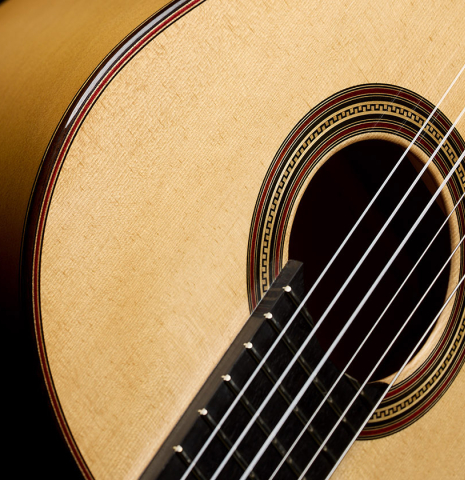 The soundboard and side of a 2021 Pepe Romero "640" classical guitar made of spruce and cypress