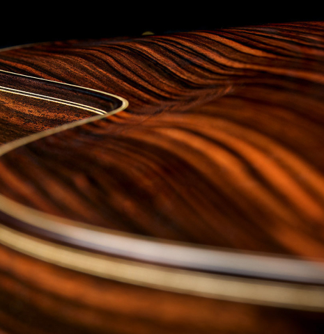 The carved back of a 2018 Jean Rompre classical guitar made of spruce and Makassar ebony