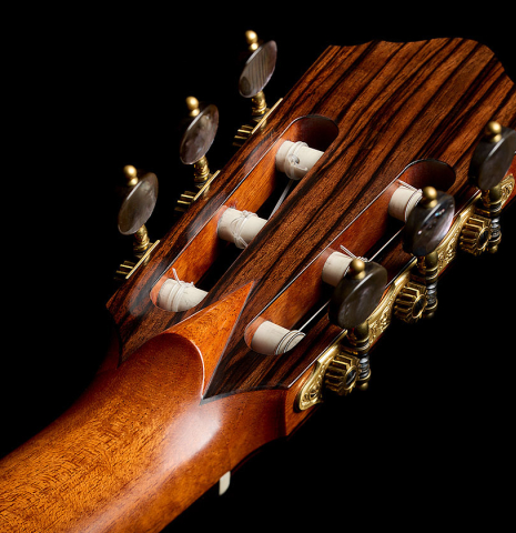 The back of the headstock of a 2018 Jean Rompre classical guitar made of spruce and Makassar ebony