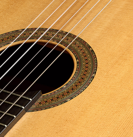 The soundboard, fingerboard and rosette of a 1999 Ignacio Rozas classical guitar made of spruce and maple