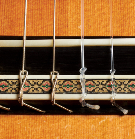 The bridge, tie-block and saddle of a 2008 Ignacio Rozas "640" classical guitar made of cedar and CSA rosewood