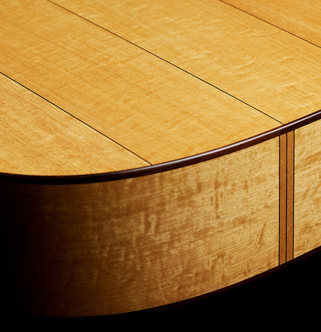 The back and sides at the foot of a 2025 Jochen Rothel classical guitar made of cedar and satinwood