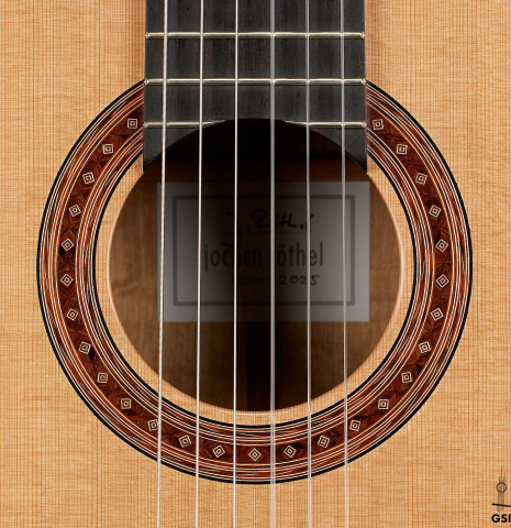 The rosette of a 2025 Jochen Rothel classical guitar made of cedar and satinwood