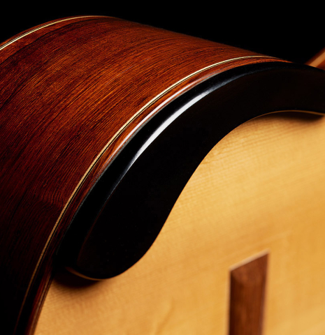 The arm rest of a 2010 Jochen Rothel classical guitar made of spruce and African rosewood