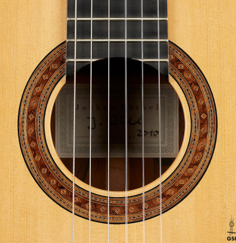 The rosette of a 2010 Jochen Rothel classical guitar made of spruce and African rosewood