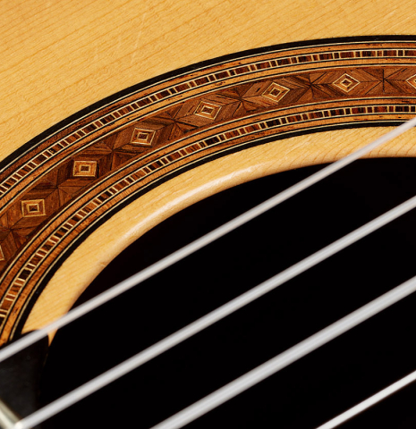 The soundboard and rosette detail of a 2010 Jochen Rothel classical guitar made of spruce and African rosewood